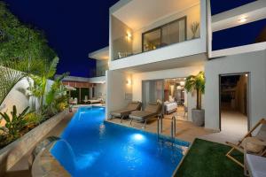 a swimming pool in the backyard of a house at Oasis Luxury Suites in Kolymbia