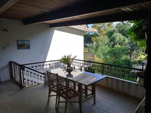 a table and two chairs on a balcony at Casa serusi in Copanello