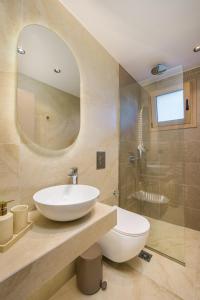 a bathroom with a white sink and a shower at MSBeach Luxury Homes - Manolis in Kos