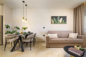 a living room with a couch and a table at MSBeach Luxury Homes - Manolis in Kos +35 photos