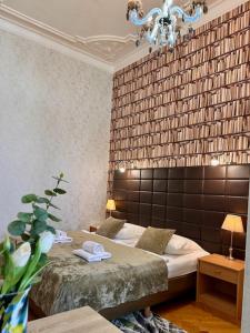 a bedroom with a bed and a large wall at Hotel Pension Bella in Berlin