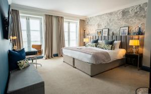 a bedroom with a large bed and a desk in it at The Gonville Hotel, a member of Radisson Individuals in Cambridge +84 photos