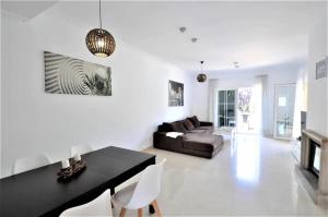 a living room with a black table and a couch at Villa Mares Puig in Llucmajor