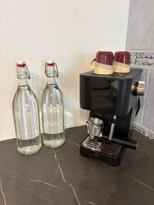 two glass bottles sitting on top of a coffee maker at Langerhof in Hannersdorf