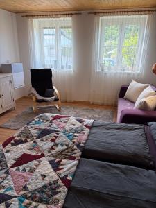 a living room with a quilt on the floor at Langerhof in Hannersdorf