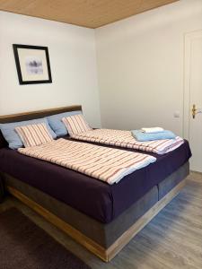 a large bed in a room with at Langerhof in Hannersdorf