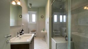 a white bathroom with a sink and a shower at Collegno Centro - Il Bumbunin... in Collegno +12 photos