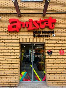 a store with a sign on a brick wall at AMISTAT Hub Hostel Budapest in Budapest +49 photos