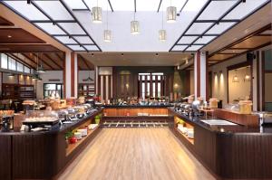 a view of a restaurant with tables and counters at The Golden Tusk By Ivory Destinations in Rāmnagar