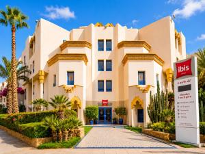 a building with a sign in front of it at Ibis Oujda in Oujda