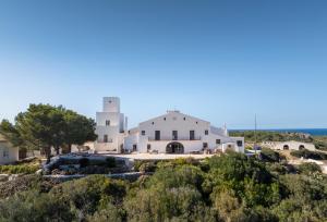 a view of a white building on a hill at Mongofre Agroturismo in Mahón