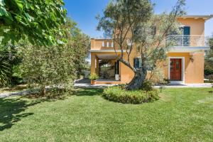 an image of a house with a yard at VK Villas in Apolpaina