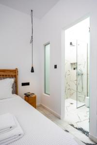 a bedroom with a bed and a glass shower at Delight Apartments suites in Stelida +137 photos