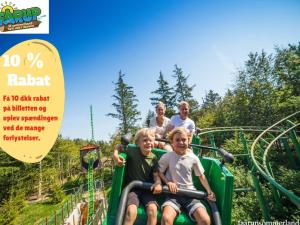 a group of people riding on a roller coaster at an amusement park at Blokhus Feriecenter in Blokhus