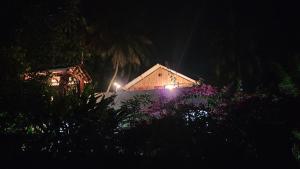 a house with lights on the side of it at night at Bhatye Beach Resort MTDC in Ratnagiri