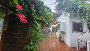 an alley with flowers on the side of a building at Bhatye Beach Resort MTDC in Ratnagiri