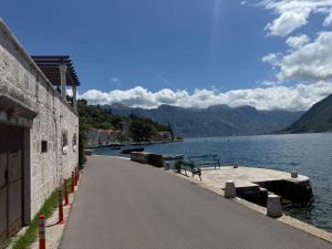 a road next to a body of water at Apartment Forteca Lux in Perast
