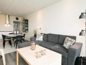 a living room with a couch and a table at Blokhus Feriecenter in Blokhus +80 photos