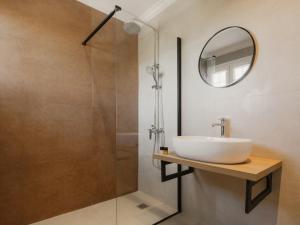 a bathroom with a sink and a shower at Cavo Notos Beach Hotel in Kavos +13 photos