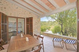 a wooden table and chairs on a patio at Villa Font in Artá