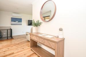 a dressing table with a mirror on a wall at Kingscote Getaway Kangaroo Island in Kingscote
