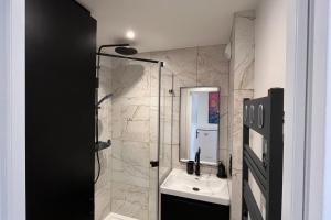 a bathroom with a sink and a glass shower at Studio with balcony and pool in La Baule in La Baule