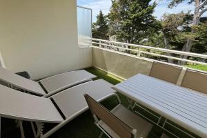 a balcony with a table and chairs and a window at Studio with balcony and pool in La Baule in La Baule