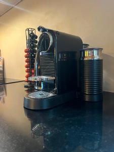 a coffee maker sitting on top of a table at B&B The White House in Westzaan