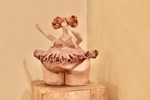 a statue of a woman sitting on a wooden block at Palazzo Cavalli Pasquini in Verona