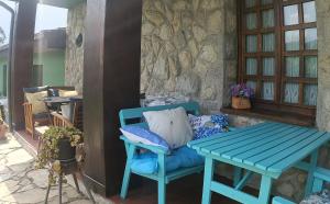 a blue table and a bench on a patio at La Xana Ribadesella in Ribadesella