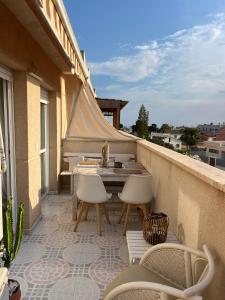 a patio with a table and chairs on a balcony at Lydia Cabo Cope in Calabardina