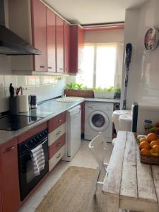 a kitchen with a sink and a stove top oven at Lydia Cabo Cope in Calabardina