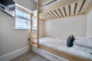 a bedroom with a bunk bed and a window at Number 6 in Margate