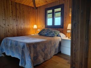 a bedroom with a bed and a window at La Xana Ribadesella in Ribadesella