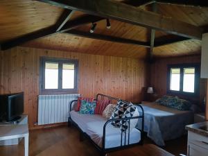 a bedroom with a bed and a couch in a room at La Xana Ribadesella in Ribadesella