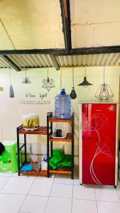 a room with a red refrigerator and a red freezer at sarisare homestay 2BR in Bulakbenda