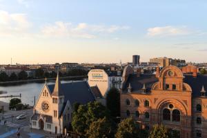 an old building with a clock tower in a city at Manon Les Suites Guldsmeden in Copenhagen +51 photos
