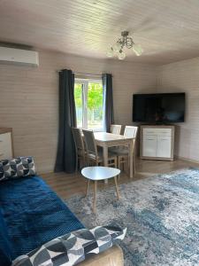 a living room with a table and a dining room at Agroturystyka nad Jeziorem Orłowskim in Wielgie