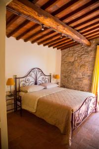 a bedroom with a large bed in a stone wall at Colombaio di Cencio in Gaiole in Chianti +54 photos