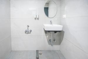 a white bathroom with a sink and a mirror at S by Z Hotels, HSR in Bangalore +15 photos