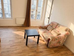 a living room with a couch and a table at Lovely Amour Hyper Centre in Caen