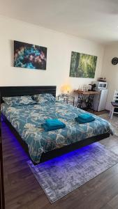 a bedroom with a bed with a blue light at Alio Room Campulung Moldovenesc in Câmpulung Moldovenesc