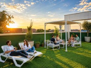 a group of people sitting in chairs on a roof at Paseo Suites Hotel in Madrid +37 photos