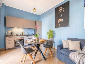 a blue living room with a table and a couch at City Gate - luxury suites in Bari