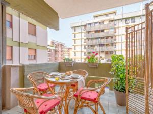a patio with a table and chairs on a balcony at City Gate - luxury suites in Bari