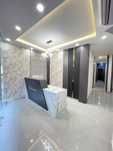 a lobby with a reception desk in a building at Hotel Lime Wood Mangaluru in Mangalore +17 photos