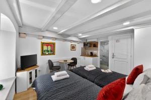 a living room with two beds and a tv at Solis Rooms Old Town in Dubrovnik