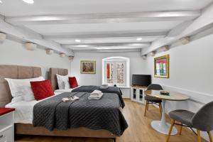 a bedroom with a bed and a table and chairs at Solis Rooms Old Town in Dubrovnik