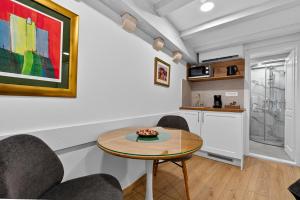 a living room with a table and chairs and a kitchen at Solis Rooms Old Town in Dubrovnik