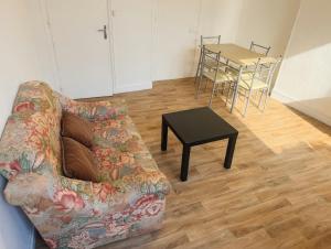 a living room with a couch and a table at Lovely Amour Hyper Centre in Caen